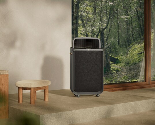 Air purifier on floor next to a window